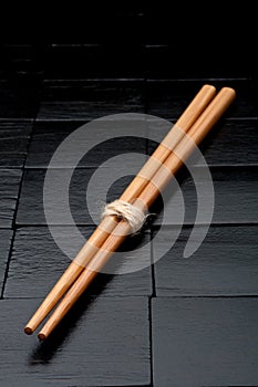 Chopsticks on a black wooden background