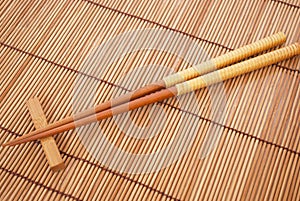 Chopsticks on brown bamboo matting background