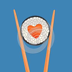 Chopsticks holding sushi roll, heart shape salmon roll, concept of snack, susi, sushi restaurant, sea food