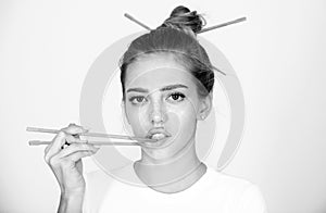 Chopsticks near sexy lips mouth. Sexy woman touch sensual lips with chopsticks. Sushi advertising.
