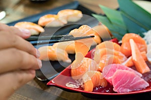 Chopsticks with Salmon sashimi with Mixed sliced fish sashimi on