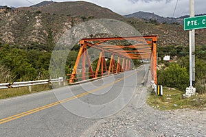 Choquechaca bridge with some vegetation and the sign indicating the place of Choquechaca photo