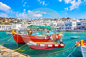 Chora port of Mykonos island with ships, yachts and boats during summer sunny day. Aegean sea, Greece