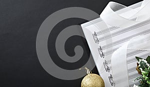 Choral christmas performance detail with binder on black table