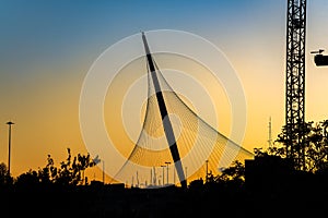 The Chords Bridge - light rail and pedestrian bridge at the entrance to Jerusalem. Bridge silhouette in sunset light.