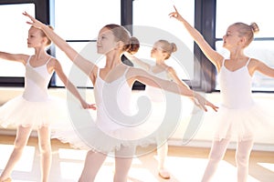 Choreographed dance by a group young ballerinas photo