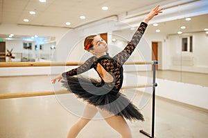 Choreographer poses at the barre, ballet school