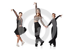 Choreographing movements. Young female dance coach practicing with kids base movements in ballroom dance isolated on
