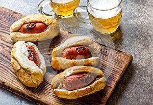 Choripan. Latin American Argentine and chilean food. Grilled chorizo sausages hot dogs served with beer, top view, stone