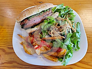 Choripan Sandwich with Wedge Fries and leafy green salad