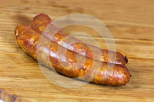 Chorizo sausage pieces on a wooden background