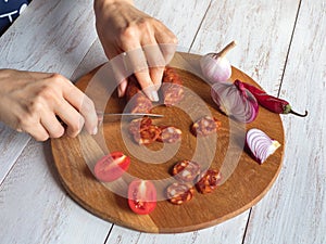 Chorizo sausage is sliced on a chopping board.