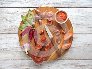 Chorizo sausage slices on a dark wooden background