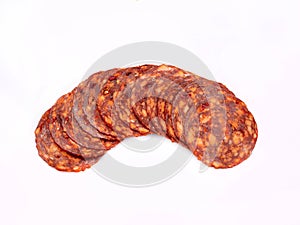 Chorizo sausage in slices, isolated. Meat cold cuts, spicy salami on white background. Packshot photo for package design