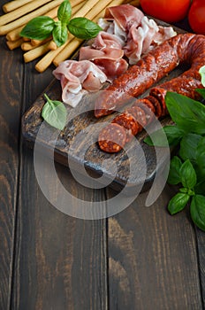 Chorizo sausage. Spanish traditional chorizo sausage and ham with fresh herbs and tomatoes.