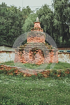 Chorten made of red colored stones in a garden in Bumthang, Bhutan