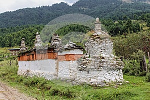 Chorten made of red and white colored stones in a garden in Bumthang, Bhutan