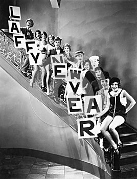 A chorus line standing on a curved stair case