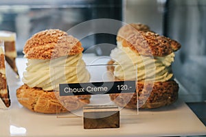 Choux Buns with Craquelin crispy cream puffs filled cream decorated photo