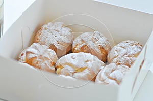 Choux cream or cream puff, eclair in the box