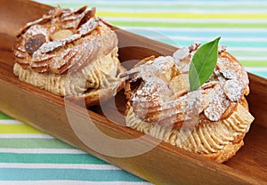 Choux Pastry in wooden plate photo