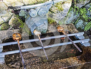 Chozuya purification fountain ladles. Traditional Japanese Shinto wash basin for ritual cleaningof worshipers