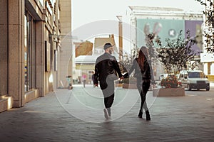 Chraming couple in love walks down the street