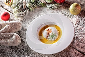 Chrismas fish soup in white plate with christmas decorations, modern gastronomy