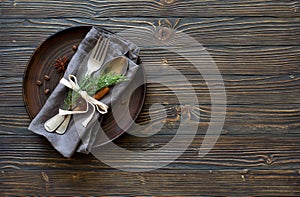 Chrismas table place setting. Tableware with evergreen twigs, co