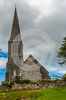 Christ church on a hill with its bell tower and surrounded by a stone fence