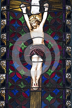 Christ crucified on Cross on colorful stained glass window in Church, Jamaica