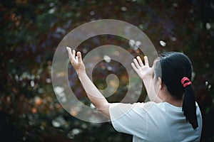 Christ religion and christianity worship or pray concept. Christian catholic woman are praying to god in dark with bokeh. Prayer