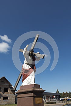 Christ statue with a cross in Wachock in Poland