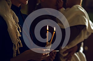 Christening in the church. Catholicism and Orthodoxy. candle on a blurred background