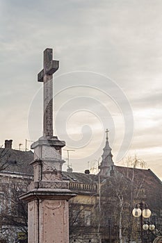 Christian and Catholic crosses, one on a calvary, one on a catholic church, at sunset. photo