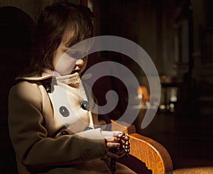 Christian child girl praying the rosary. Faith, religion concept