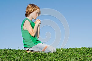 Christian child kneeling praying