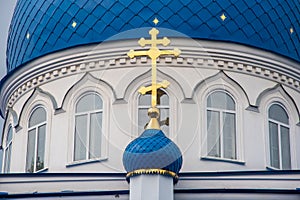 Christian Church of white stone with blue domes with stars and gold crosses.