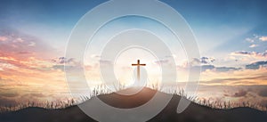 Christian concept: Silhouette cross on  mountain sunset background