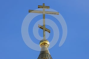 Christian cross against the blue sky. Orthodox Church