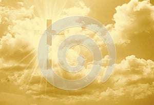 Christian cross appears bright in the yellow sky