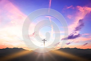 Christian cross concept: Silhouette cross on  mountain sunset background