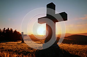 Christian cross in countryside at sunset. Christian cross in nature at sunrise. Generative AI.