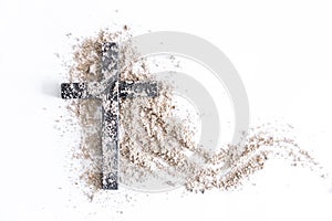 Christian cross or crucifix drawing in ash, dust or sand as symbol of religion, sacrifice, redemption, Jesus Christ, ash wednesday