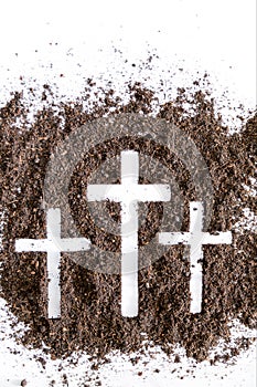 Christian cross or crucifix drawing in ash, dust or sand as symbol of religion, sacrifice, redemption, Jesus Christ, ash wednesday