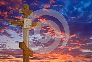 Christian cross on evening dramatic sky background