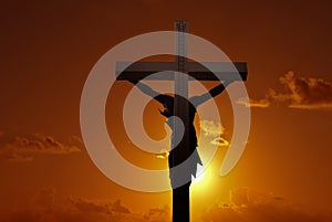 Christian cross with Jesus Christ over sunset