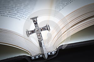 Christian cross necklace on Holy Bible book, Jesus religion concept as good friday or easter festival