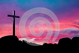 Christian cross over beautiful sunset background