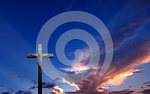 Christian cross over beautiful sunset background